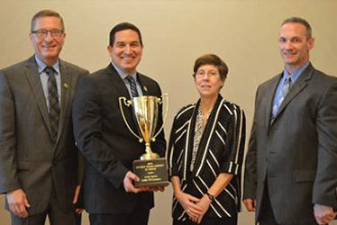DPS employees Sgt. Kelly Wilkison (from left), Sgt. Jose Chavarria and Lt. Greg Davis accept the "Fittest State Agency" award from Janna Zumbrun, Assistant Commissioner of the Division for Disease Control and Prevention Services for Texas Department of State Health Services.